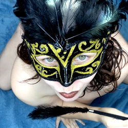 Adult Model in Masquerade Mask and Feather Earrings