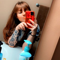 Young Woman Posing in Bathroom Mirror