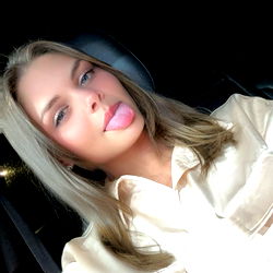 A Young Woman Posing in a Car