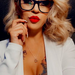 Stylish Woman with Tattoos and Red Lipstick