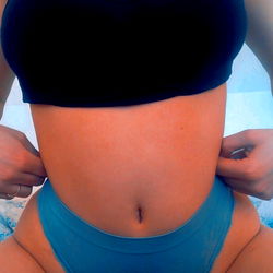 Domik, OnlyFans Model, Striking a Pose in a Tank Top and Thong