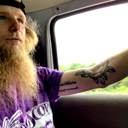 The onlyfans model, Preston Peace, posing in a truck