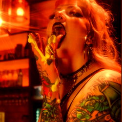 Stylish Tattooed Individual with Yellow Ooze