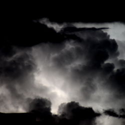 A dramatic night scene under a dense, stormy sky