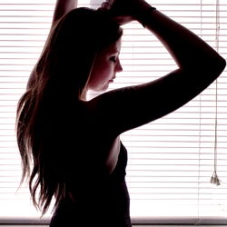 A Woman in a Tight Dress Looking Out a Window