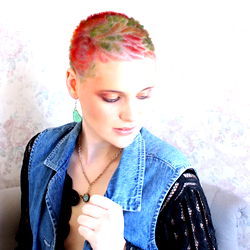 OnlyFans Model Ashley, Sporting Pink Mohawk Hair Style with a Bold Vest and Necklace