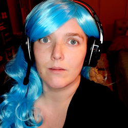 Gaming enthusiast with vibrant blue hair in headphones