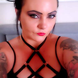 Stylish OnlyFans Model With Dark Eyes and Tattoos