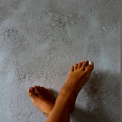 Posed Pair of Feet on Wall