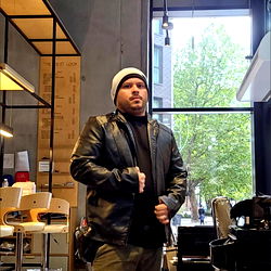 A London-based fashion influencer stands proudly in a modern salon