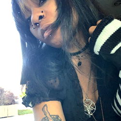 Tattooed Woman with Piercings, Smiling at Camera