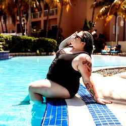 Maeve Free lounges poolside