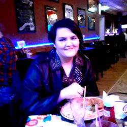 A Woman Enjoying a Meal at a Restaurant