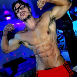 Fitness Model JSSD VINDELMAN Showcasing Physique in Red Shorts