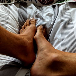 RizzJizz on a bed with feet in the air