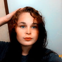 A woman posing in front of a mirror