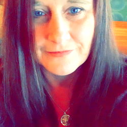 A woman with short hair and a necklace,