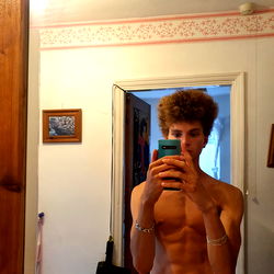 OnlyFans Model Aliy: Shirtless and Smiling in Bathroom Mirror