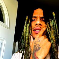 Rapper Exuding Confidence, Sporting Dramatic Hair