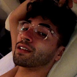 David, an OnlyFans model, lounging in a hotel room