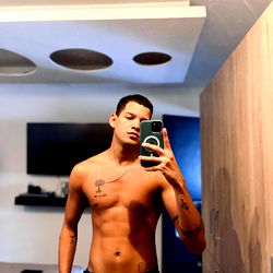 Fitness Model Showcasing His Shirtless Physique in a Hotel Room