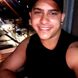 Alejandro posing for a photo on a balcony