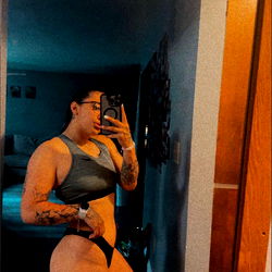 Villeda in Bodybuilding Pose, Showcasing Tattoos and Bikini