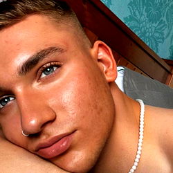 Andrew, a 25-year-old male model from Glasgow, captures his moment of relaxation with a unique pose on the bed.