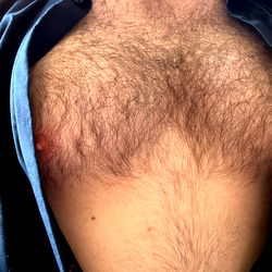 Dhorns, a OnlyFans Model from England, Showcasing Chest Tattoo