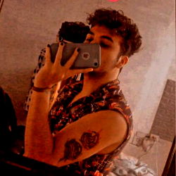 Stylish Male Model Carlos Martinez Taking a Selfie with Phone in Hand