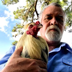 Man holding rooster