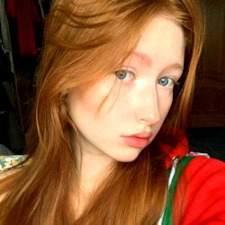 A Portrait of Elizabeth, a 19-year-old female model with vibrant red hair and captivating blue eyes