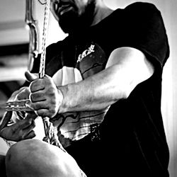 Adult Male Using Suspension System Equipment