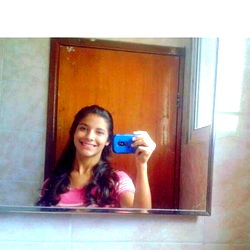 A Posing for the Camera in a Bathroom Mirror