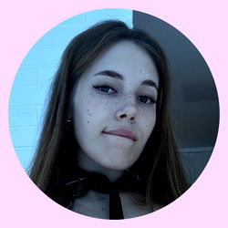 Stylish Anastasia with a playful expression, taking a selfie in a modern setting.