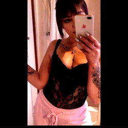 Flossaaaybaby, a model in a black lace bodysuit and pink pants