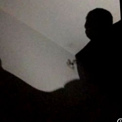 A solitary figure in a dark room