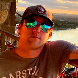 A Man with Sunglasses at a Balcony