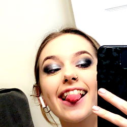 A young woman taking a mirror selfie