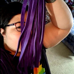 A person holding purple ribbons