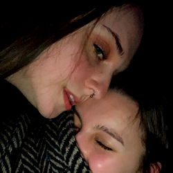 Two Women Share a Smile in the Dark