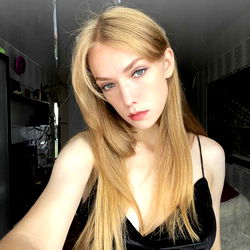 OnlyFans Model Alisa, Captivating in Her Black Velvet Dress with Long Blonde Hair