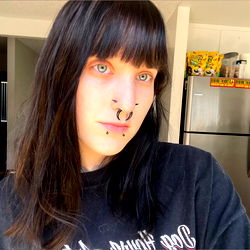 Woman in Grey T-shirt with Nose Piercing and Short Bob