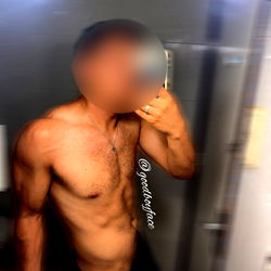 OnlyFans Model Showcasing Shirtless Physique in Bathroom Mirror