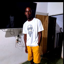 Jorman Murillo posing in a room with a TV and an open door