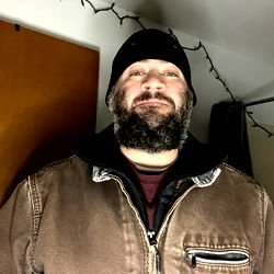 A Man in a Winter Coat Smiling at the Camera