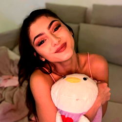 Ashley in a cozy pose with a plush toy