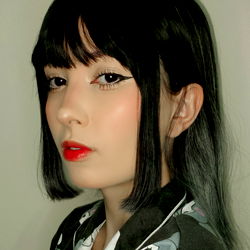 Aesthetic Japanese-inspired style with bangs, red lipstick and a black cat hair clip.