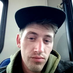 Young Man with Cap, Hoodie and Tattoo