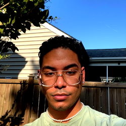 CJ on a sunny day in sunglasses and a green top